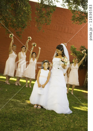 Hispanic bride and bridesmaids holding bouquets Hispanic bride and bridesmaids holding bouquets 11636583