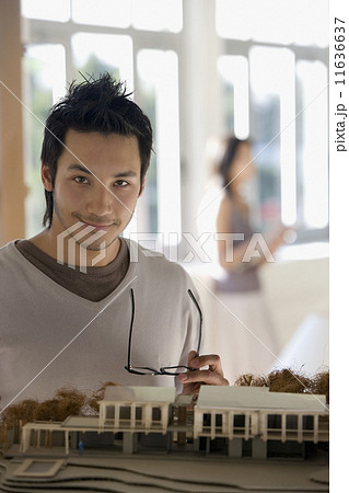 Asian male architect next to model Asian male architect next to model 11636637