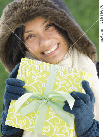 Pacific Islander woman holding gift 11636676