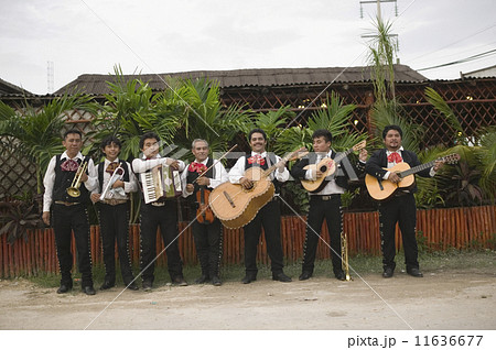 Mariachi band in front of building playing their instruments 11636677