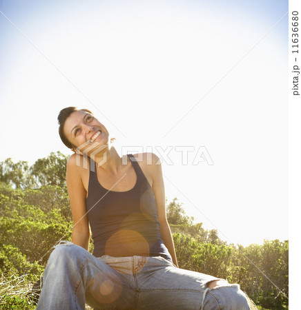 Woman sitting in grass Woman sitting in grass 11636680