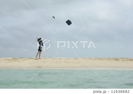 Hispanic businesswoman throwing briefcase in air 11636682