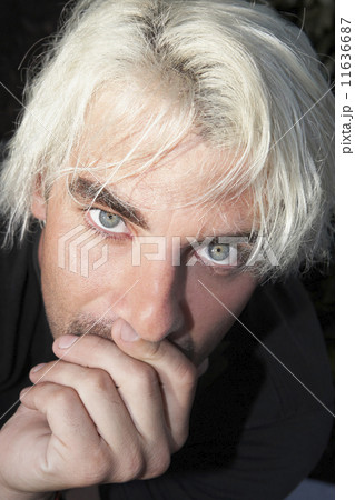 Hispanic man resting chin in hand Hispanic man resting chin in hand 11636687