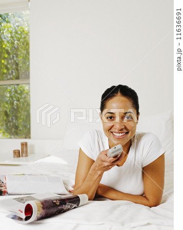 African woman holding remote control African woman holding remote control 11636691