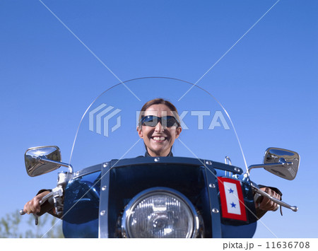 Hispanic woman sitting on motorcycle Hispanic woman sitting on motorcycle 11636708