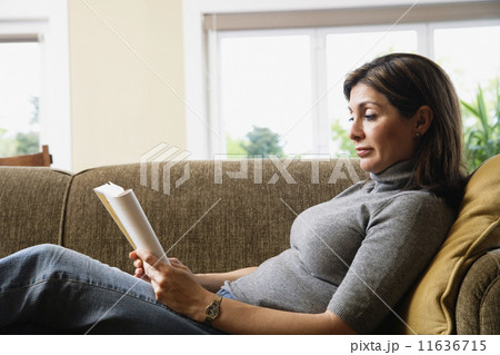 Slavic woman reading on sofa 11636715