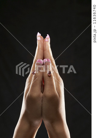Indian woman's hands with jeweled fingernails 11636740
