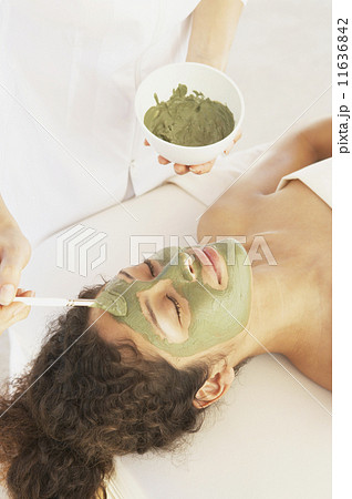 Woman on massage table getting facial treatment  11636842