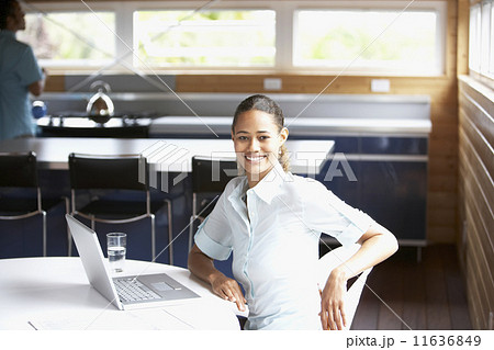 Mixed Race woman sitting with laptop 11636849
