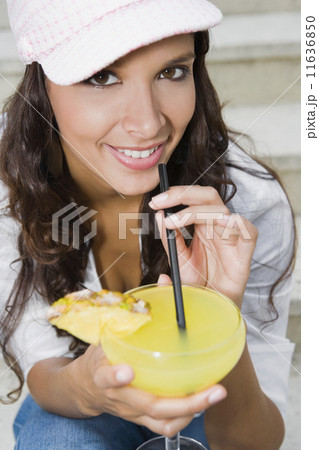Hispanic woman drinking cocktail Hispanic woman drinking cocktail 11636850