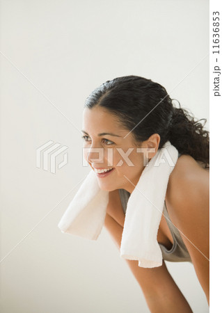 Sweating woman with a towel around her neck 11636853