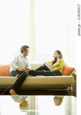 Hispanic couple sitting on sofa Hispanic couple sitting on sofa 11636917