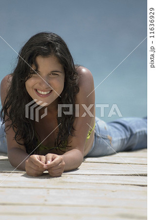 Hispanic woman laying on dock Hispanic woman laying on dock 11636929