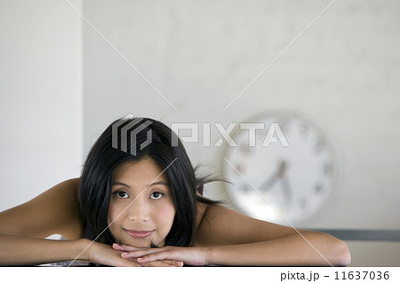 Asian woman resting chin on hands 11637036