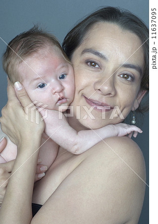 Hispanic mother hugging baby 11637095