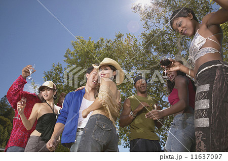 Low angle view of friends dancing at party 11637097