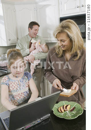 Family in kitchen at breakfast time Family in kitchen at breakfast time 11637180