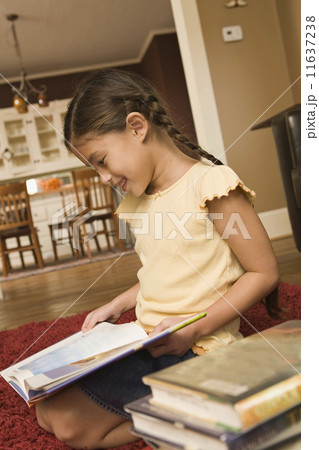 Pacific Islander girl reading library book 11637238