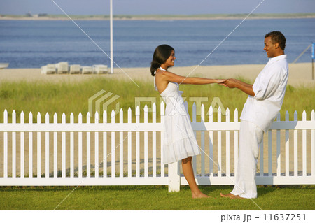 Couple holding hands at beach Couple holding hands at beach 11637251