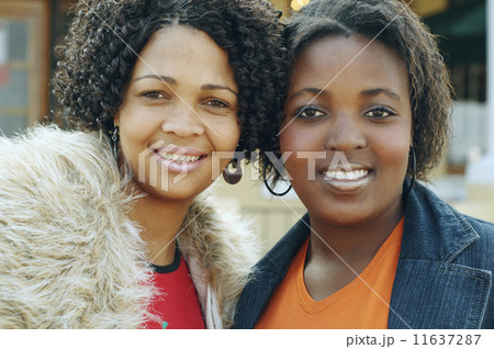 Multi-ethnic women hugging 11637287