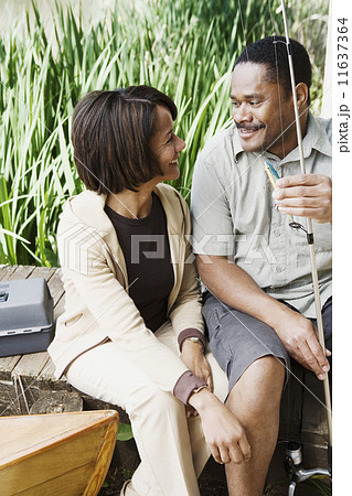 Middle-aged African couple smiling with fishing gear Middle-aged African couple smiling with fishing gear 11637364