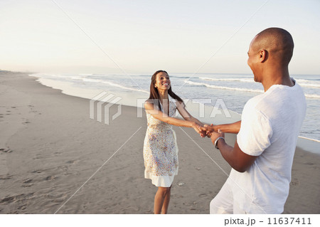 African couple playing on beach 11637411