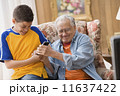 Young boy and his grandfather fighting over the remote control 11637422