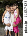 Hispanic father hugging daughters 11637423