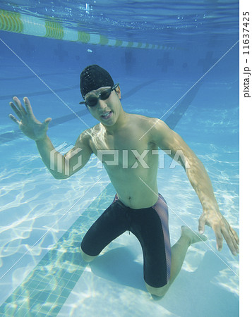 Underwater shot of Asian man waving Underwater shot of Asian man waving 11637425