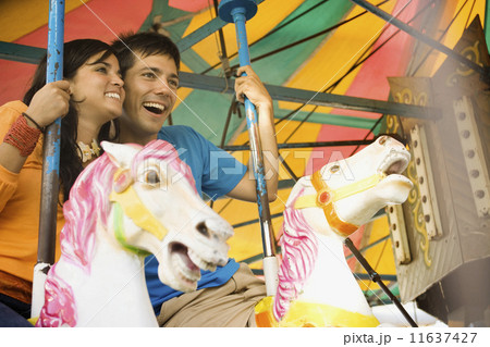 Couple riding a rollercoaster Couple riding a rollercoaster 11637427