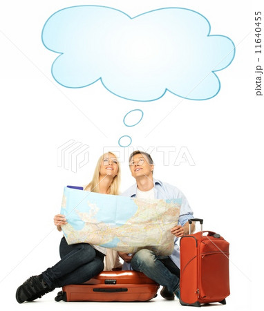 Smiling beautiful young couple with a map sitting on a suitcase 11640455