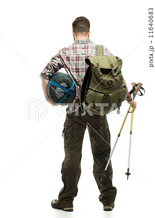 Traveler with backpack, hiking poles and sleeping bag 11640683
