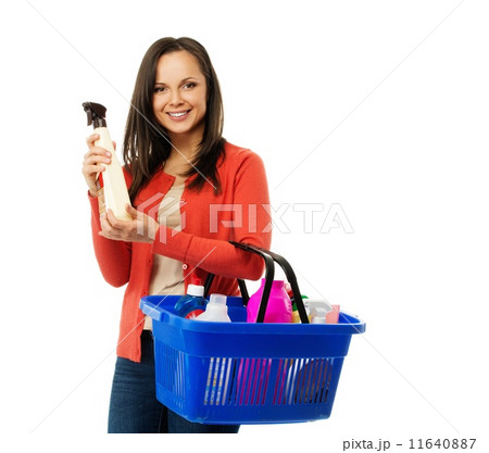 Beautiful cheerful brunette woman with basket full and bottle of cleanser 11640887