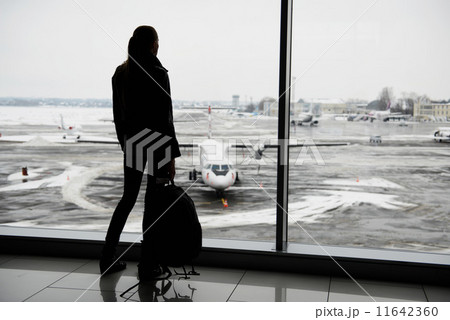 Woman standing in the airport terminal Woman standing in the airport terminal 11642360