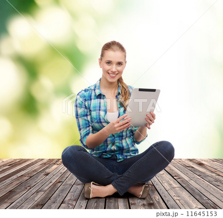 young woman in casual clothes sitting on floor 11645153