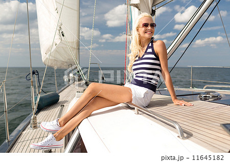 smiling young woman sitting on yacht deck 11645182