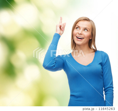 smiling woman pointing her finger up smiling woman pointing her finger up 11645263