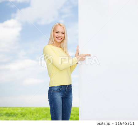 smiling woman in sweater with blank white board 11645311
