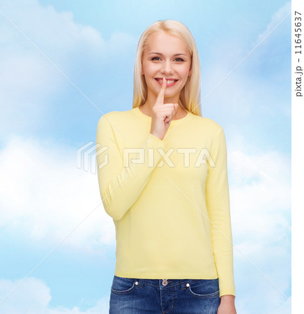 young woman with finger on her lip young woman with finger on her lip 11645637