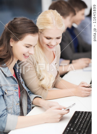 students with computer monitor and smartphones 11645899