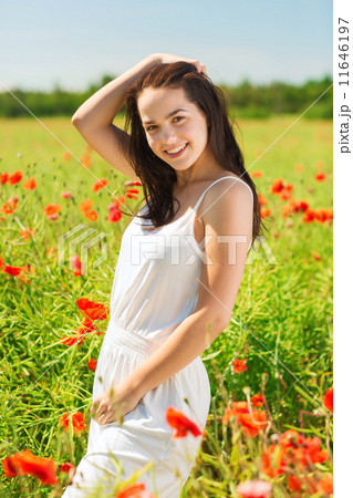 smiling young woman on poppy field smiling young woman on poppy field 11646197