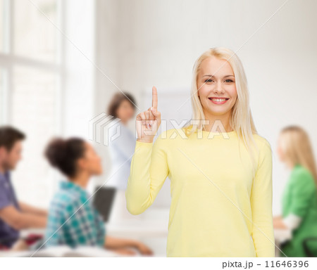 smiling woman pointing her finger up 11646396