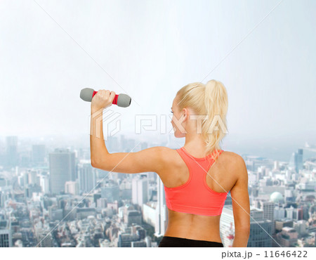 young sporty woman with light dumbbell 11646422
