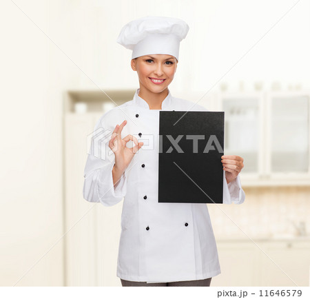 smiling female chef with black blank paper 11646579