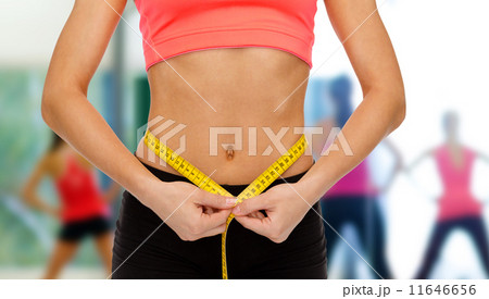 close up of female hands measuring waist close up of female hands measuring waist 11646656