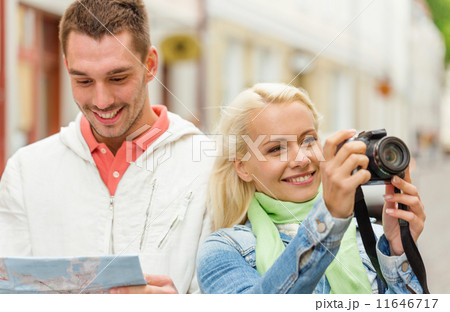 smiling couple with map and photocamera in city smiling couple with map and photocamera in city 11646717