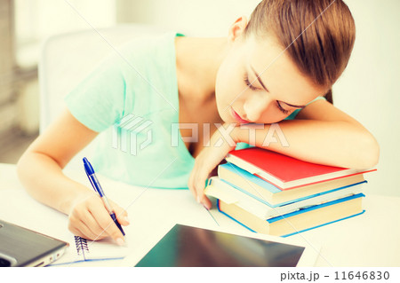 tired student sleeping on stock of books tired student sleeping on stock of books 11646830