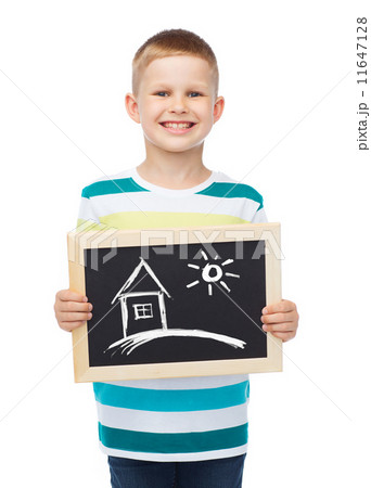 smiling little boy holding chalkboard with home smiling little boy holding chalkboard with home 11647128