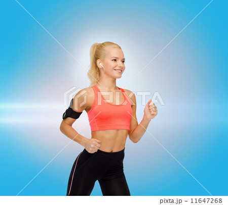 sporty woman running with smartphone and earphones sporty woman running with smartphone and earphones 11647268