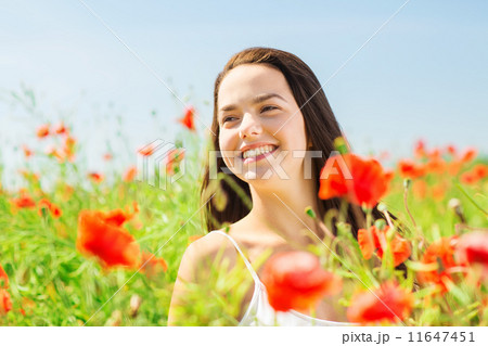 smiling young woman on poppy field 11647451